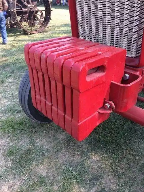 答:这是拖拉机配重铁,如果你拉着一个很重的东西,拖拉机前轮摩擦力就