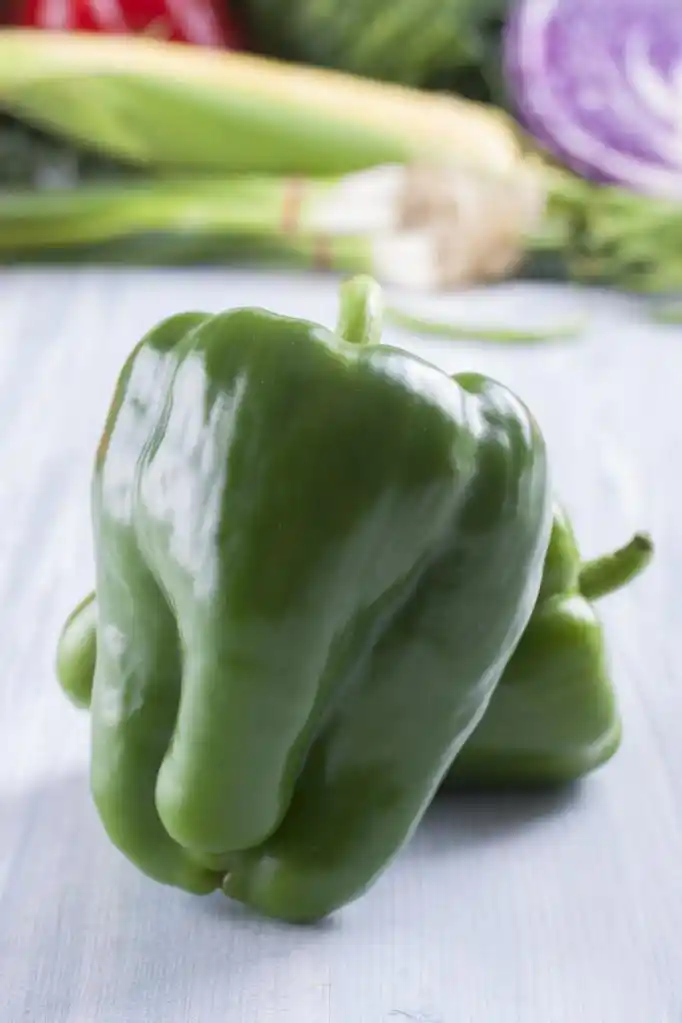 蔬菜,密切了照片的食用蔬菜-固体淡蓝色木制表上背景中一些蔬菜青椒