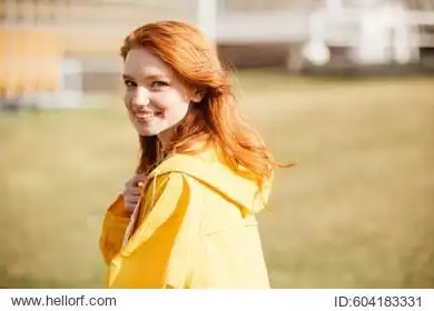portrait of a friendly pretty ginger hair girl in coat outdoors