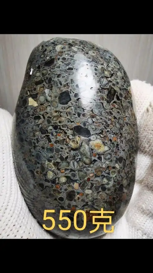 五彩球粒陨石精品,随型抛光手把件