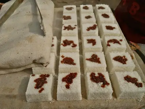 这个是"米糕",是用大米磨碎成粉末状,蒸出来的,然后上面放的是豆沙.