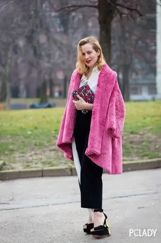 白衬衫着黑色阔腿裤外披艳粉色毛绒外套,打破了黑白色带来的沉闷感.