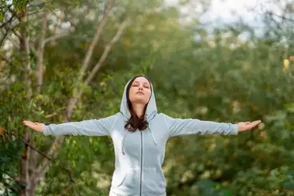 在公园里做深呼吸练习的美女照片