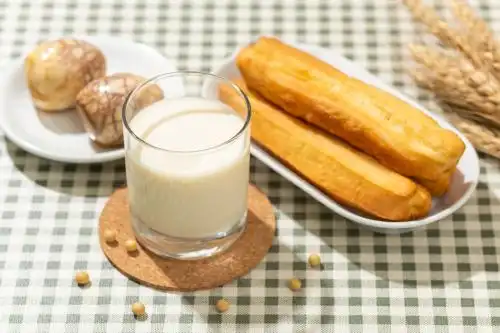 豆浆油条茶叶蛋特写格子桌布背景