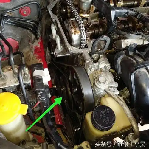 下图所示,汽修师傅已经把正时链条的外壳以及侧面的发电机皮带