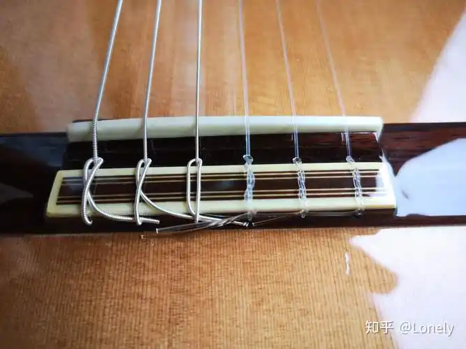 古典吉他琴桥每根弦有两个孔怎么上弦