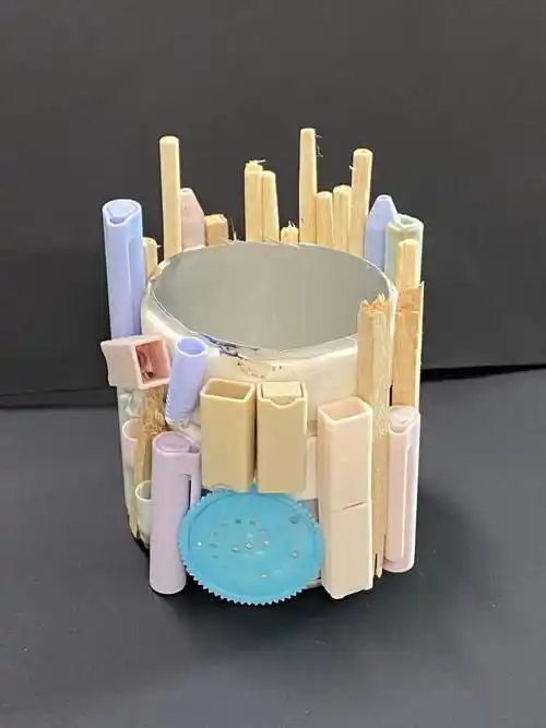 他巧妙地运用一次性筷子和废弃的笔芯作为装饰,使得这个笔筒不仅具有