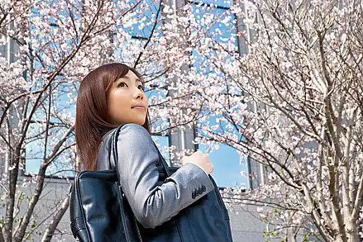 站在樱花树下的年轻女性情侣剪影情侣剪影女孩,放松,树下小,小教堂,树