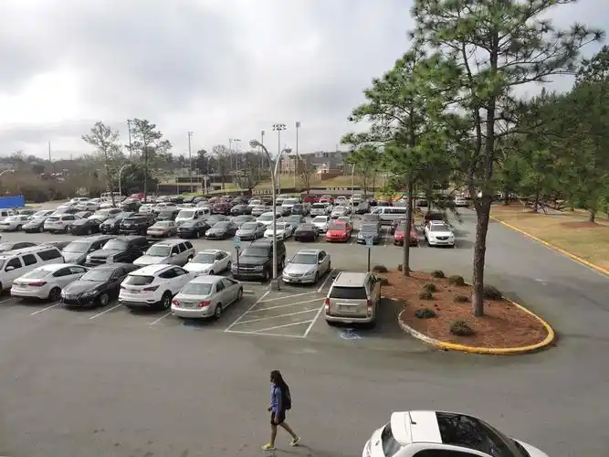 student passes through the parking lot behind stetson to get to