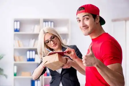 女商人从信使接收邮件包裹照片