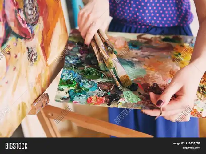 artist paints a picture of oil paint brush in