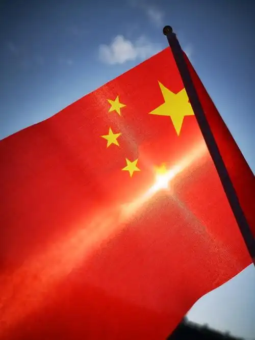 九月晴空,朝阳下的五星红旗闪动着最美的颜色