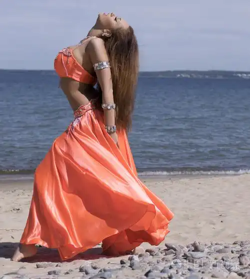 海头附近的橙色服装的肚皮舞