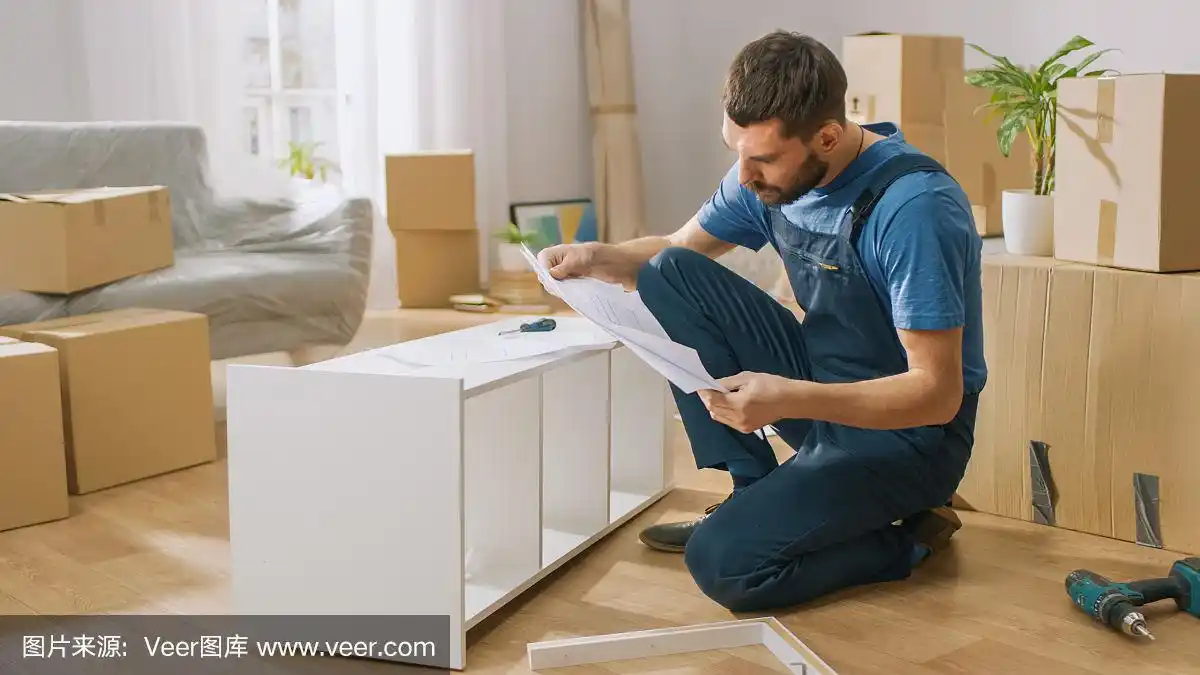 成功的家具组装工人使用螺丝刀组装架子,参考说明书.