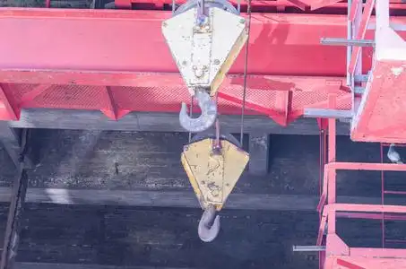 两个起重机吊钩救援机用钢丝绳电动绞车挂上起重钢丝绳的旧管.