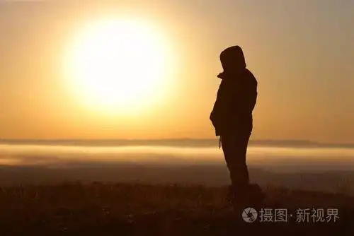 强烈的精神女孩站在一天的日出时面对太阳